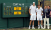 John Isner and Nicolas Mahut stand with the Wimbledon scoreboard after the longest tennis match in history.