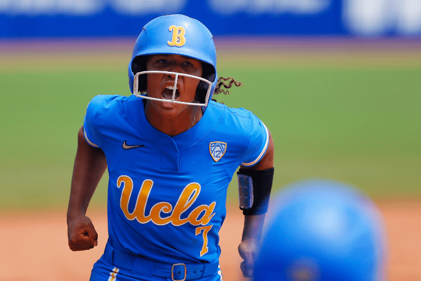 Maya Brady #7 of the UCLA Bruins pumps her fists as she rounds third base with a three-run home run against the Oklahoma Sooners in the third inning during the NCAA Women's College World Series at the USA Softball Hall of Fame Complex