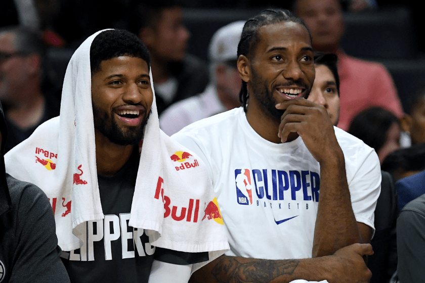 Paul George and Kawhi Leonard smile on the Clippers Bench