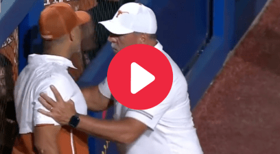 Texas assistant coach Steve Singleton had to be restrained at the WCWS.