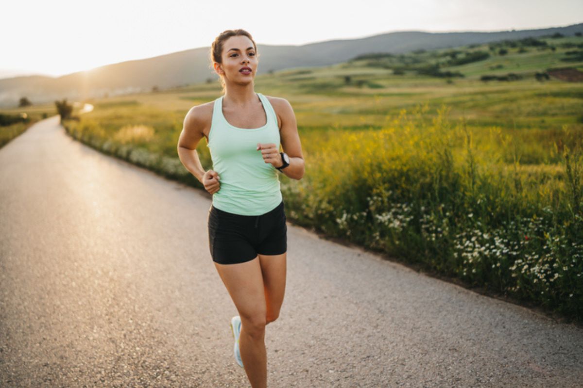 Portrait of confident female runner jogger training outdoors on