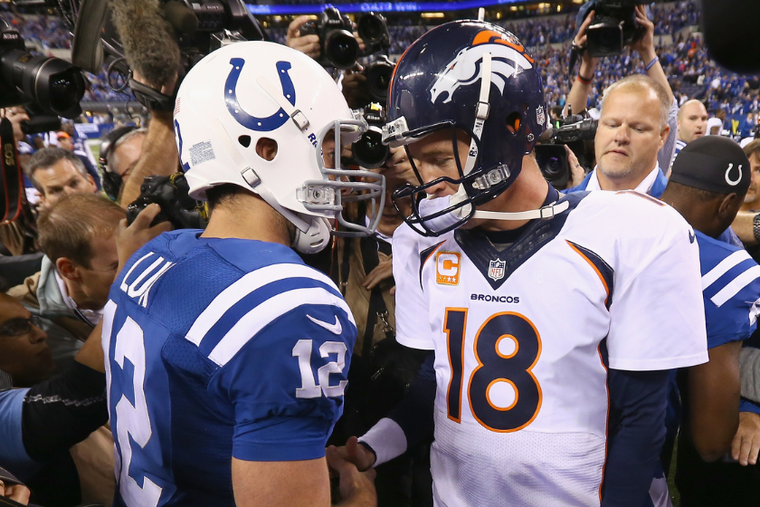 Andrew Luck #12 of the Indianapolis Colts and Peyton Manning #18 of the Denver Broncos meet after the game at Lucas Oil Stadium