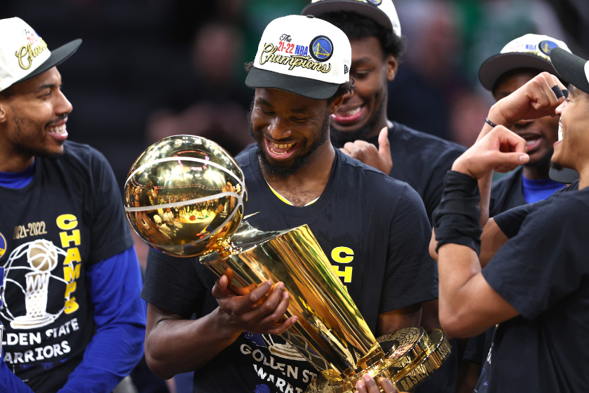 Andrew Wiggins #22 of the Golden State Warriors celebrates with the Larry O'Brien Championship Trophy