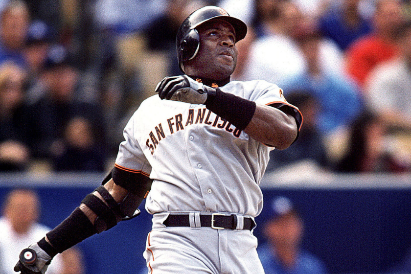 Barry Bonds watches a home run leave the ballpark