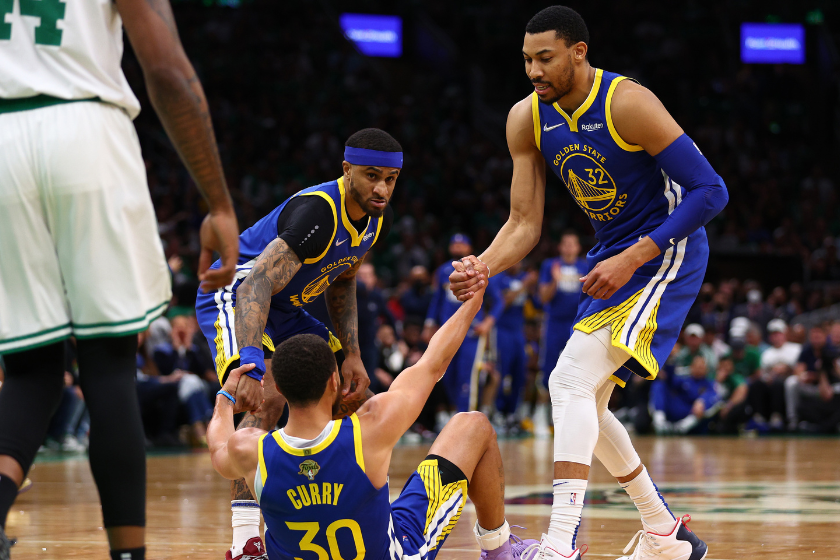  Otto Porter Jr. #32 and Gary Payton II #0 of the Golden State Warriors help Stephen Curry #30 up against the Boston Celtics