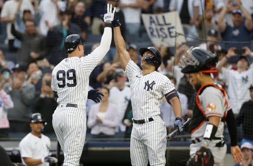 Giancarlo Stanton and Aaron Judge celebrate after a home run in 2022.