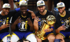 Andre Iguodala #9, Draymond Green #23, Klay Thompson #11 and Stephen Curry #30 of the Golden State Warriors pose for a photo after defeating the Boston Celtics