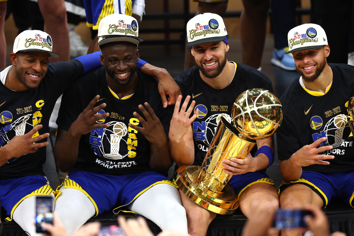Andre Iguodala #9, Draymond Green #23, Klay Thompson #11 and Stephen Curry #30 of the Golden State Warriors pose for a photo after defeating the Boston Celtics