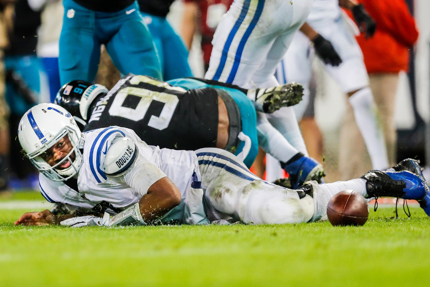 Jacoby Brissett #7 of the Indianapolis Colts looks at a loose ball after fumbling during the fourth quarter of a game against the Jacksonville Jaguars
