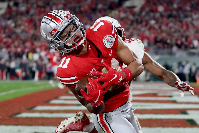 Jaxon Smith-Njigba of the Ohio State Buckeyes catches a touchdown pass against the Utah Utes during the fourth quarter in the 2021 Rose Bowl Game.