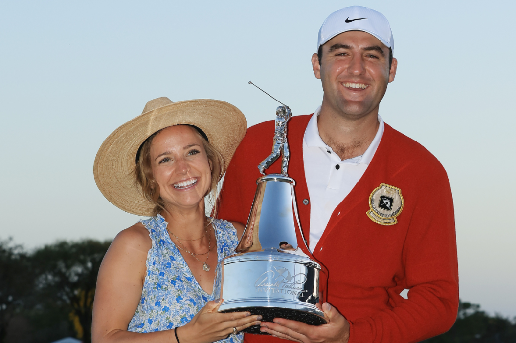 Scottie Scheffler of the United States poses with the trophy and his wife, Meredith Scheffler, after winning the Arnold Palmer Invitational