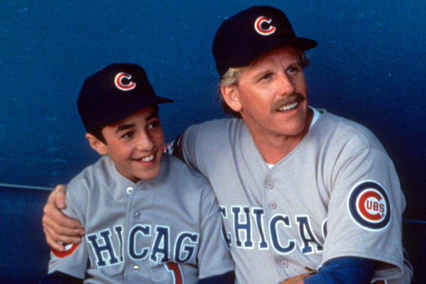 Thomas Ian Nicholas on dugout bench with Gary Busey in a scene from the film 'Rookie Of The Year'