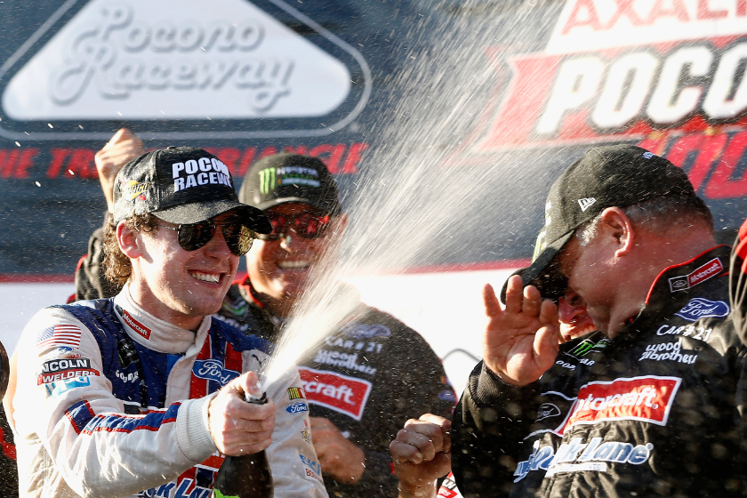 Ryan Blaney celebrates in Victory Lane after winning the Monster Energy NASCAR Cup Series Axalta presents the Pocono 400 at Pocono Raceway on June 11, 2017 in Long Pond, Pennsylvania)