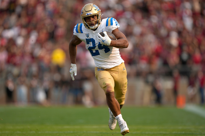 UCLA running back Zach Charbonnet carries the ball upfield against the Stanford Cardinal