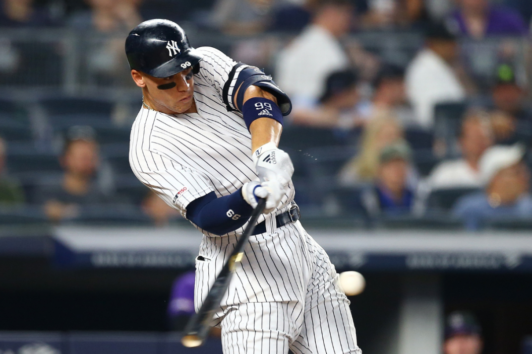 Aaron Judge #99 of the New York Yankees hits a two-run home run to right field in the sixth inning against the Colorado Rockies