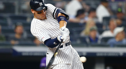 Aaron Judge #99 of the New York Yankees hits a two-run home run to right field in the sixth inning against the Colorado Rockies