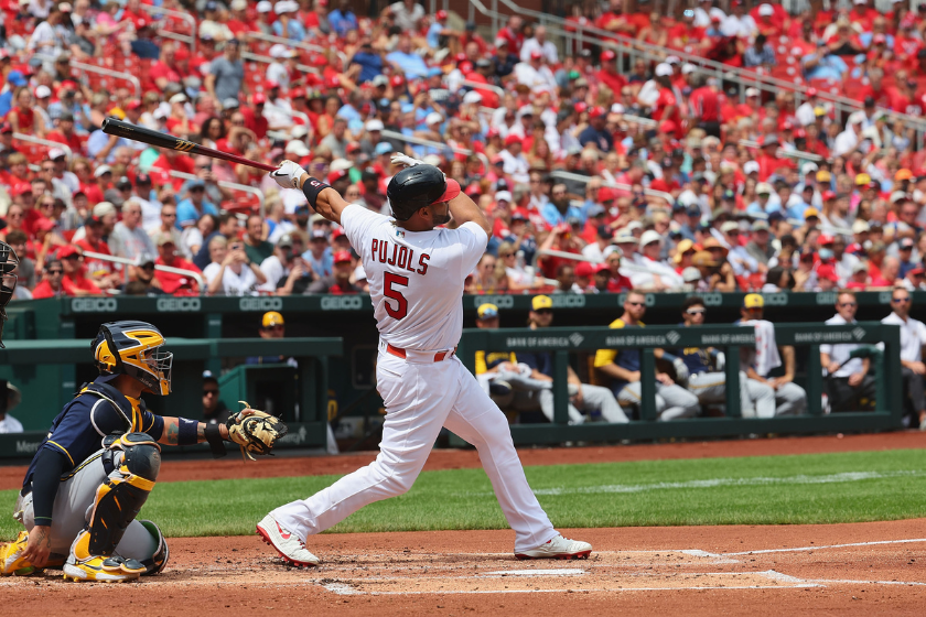 Albert Pujols hits a home run against the Milwaukee Brewers.