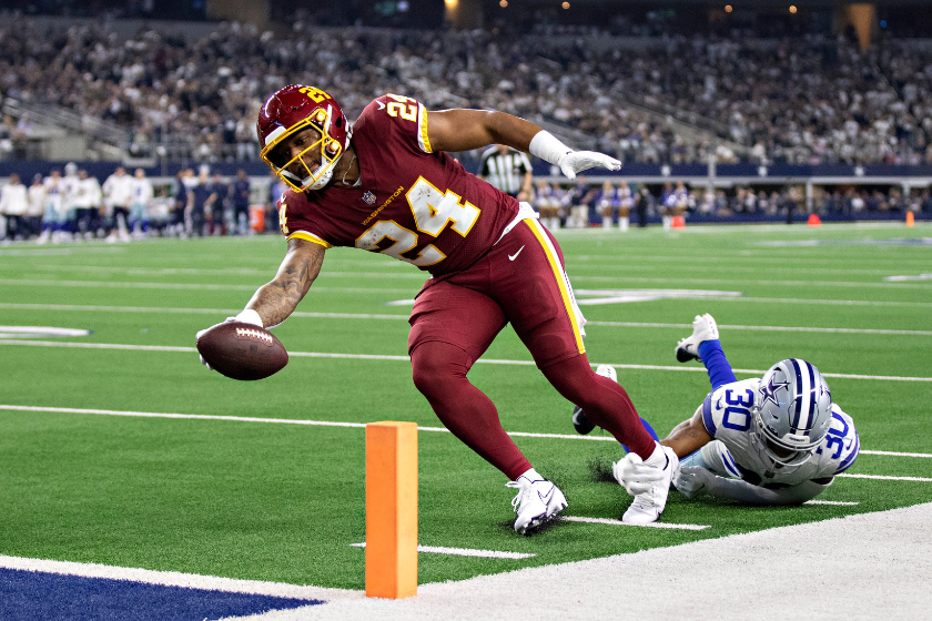 Antonio Gibson reaches across the goal line against the Dallas Cowboys.