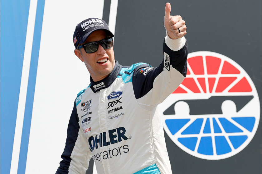 Brad Keselowski gives a thumbs up to fans as he walks onstage during driver intros prior to the NASCAR Cup Series Ambetter 301 at New Hampshire Motor Speedway on July 17, 2022