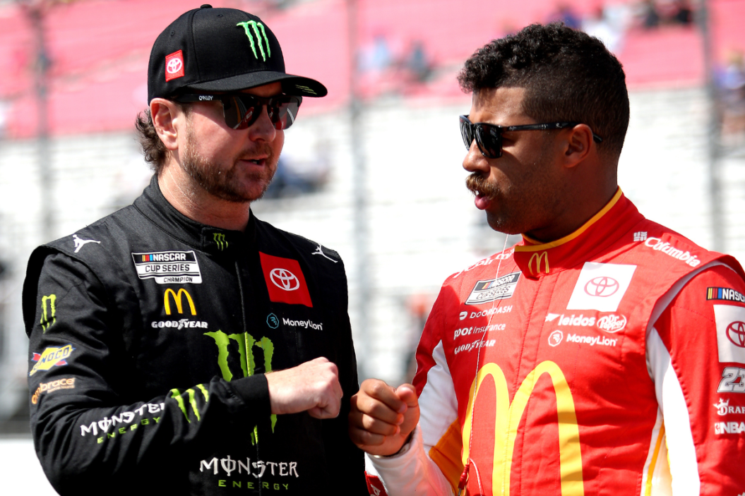 Bubba Wallace and Kurt Busch fist bump on the grid during qualifying for the NASCAR Cup Series Enjoy Illinois 300 at WWT Raceway on June 04, 2022