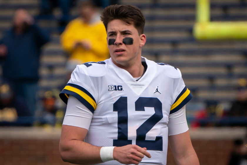 Cade McNamara #12 of the Michigan Wolverines walks on the field during warm ups of the spring football game