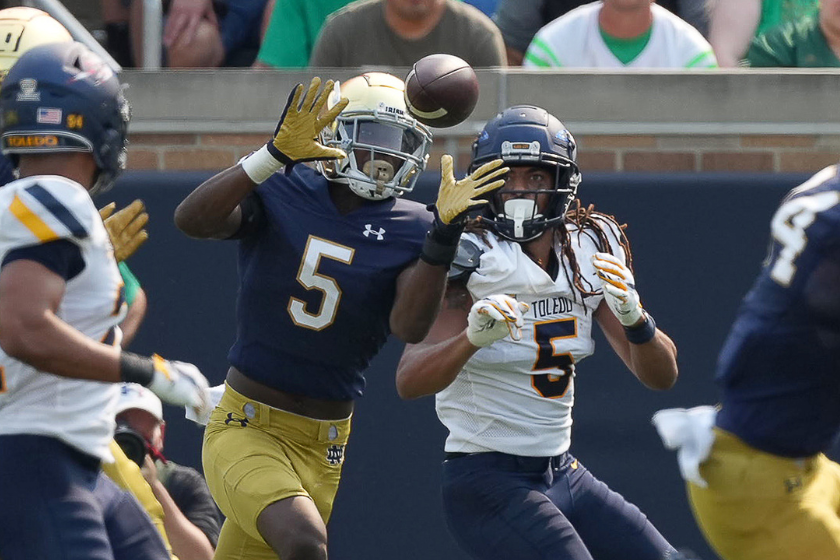 Notre Dame Fighting Irish cornerback Cam Hart (5) battles with Toledo Rockets wide receiver Bryce Mitchell (5) during a game between the Notre Dame Fighting Irish and the Toledo Rockets 