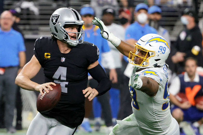 Quarterback Derek Carr #4 of the Las Vegas Raiders avoids a sack by defensive end Jerry Tillery #99 of the Los Angeles Chargers