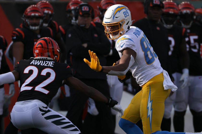 Donald Parham Jr. #89 of the Los Angeles Chargers runs with the ball while being chased by Chidobe Awuzie #22 of the Cincinnati Bengals