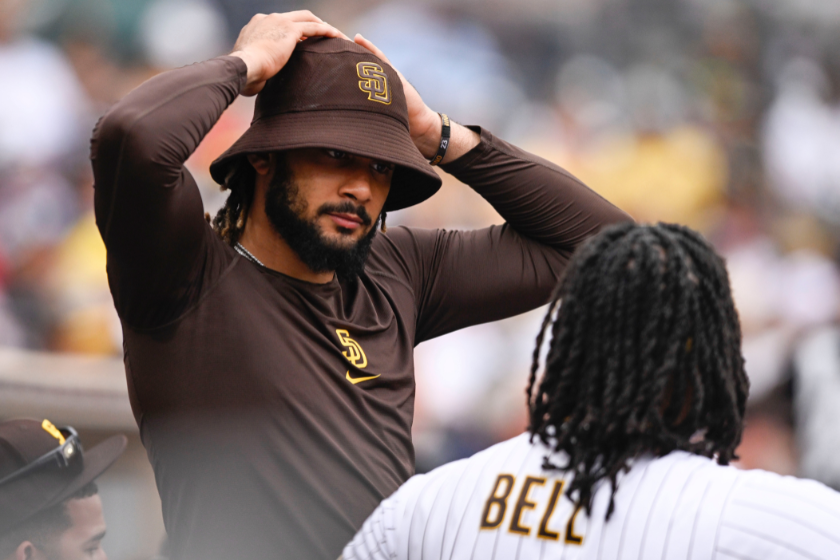 Fernando Tatis Jr. #23 of the San Diego Padres talks with Josh Bell #24 during a baseball game against the Colorado Rockies