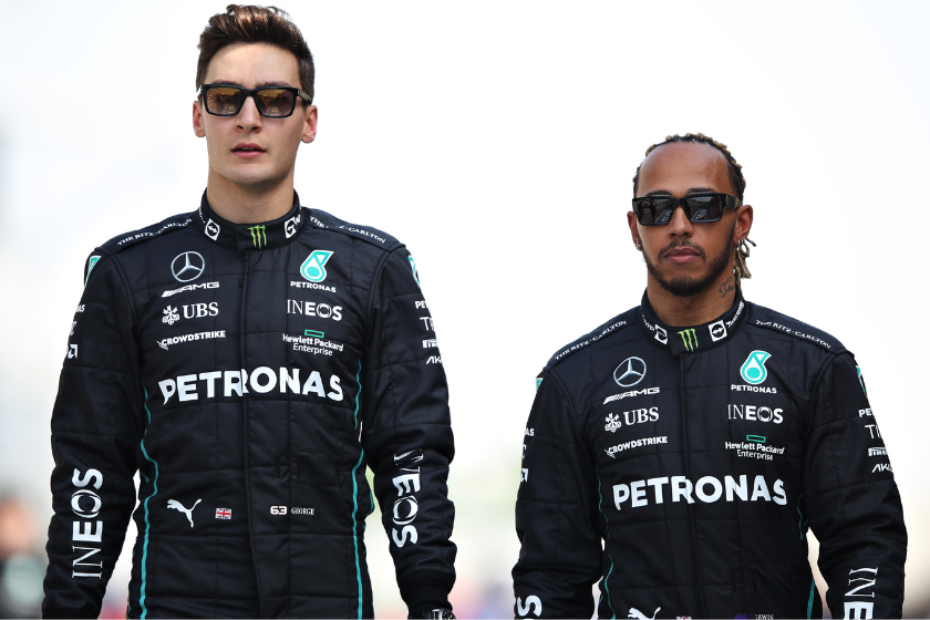 George Russell of Great Britain and Mercedes and Lewis Hamilton of Great Britain and Mercedes walk in the Paddock during Day One of F1 Testing at Bahrain International Circuit 