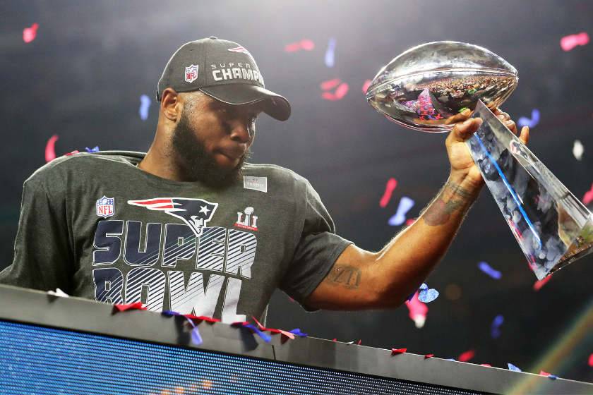 James White #28 of the New England Patriots holds the Vince Lombardi Trophy to celebrate after defeating the Atlanta Falcons 34-28 in overtime