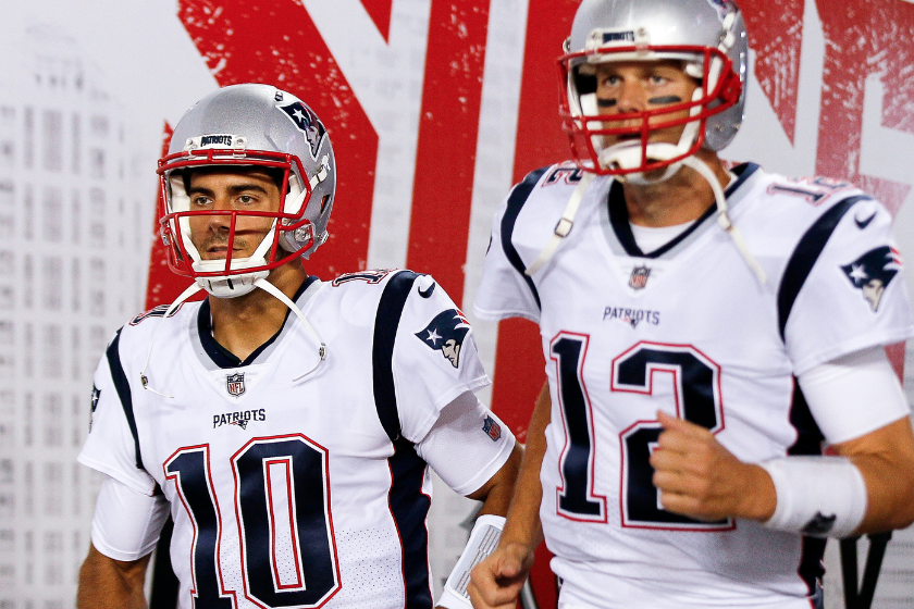 Quarterbacks Jimmy Garoppolo and Tom Brady #10 of the New England Patriots as they enter the field for pre-game warm-ups