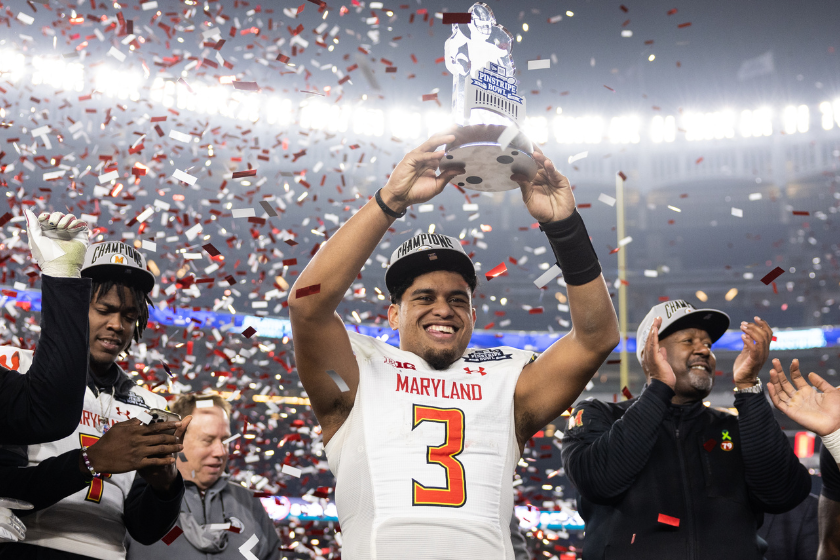 Taulia Tagovailoa #3 of the Maryland Terrapins holds the MVP trophy after winning the New Era Pinstripe Bowl