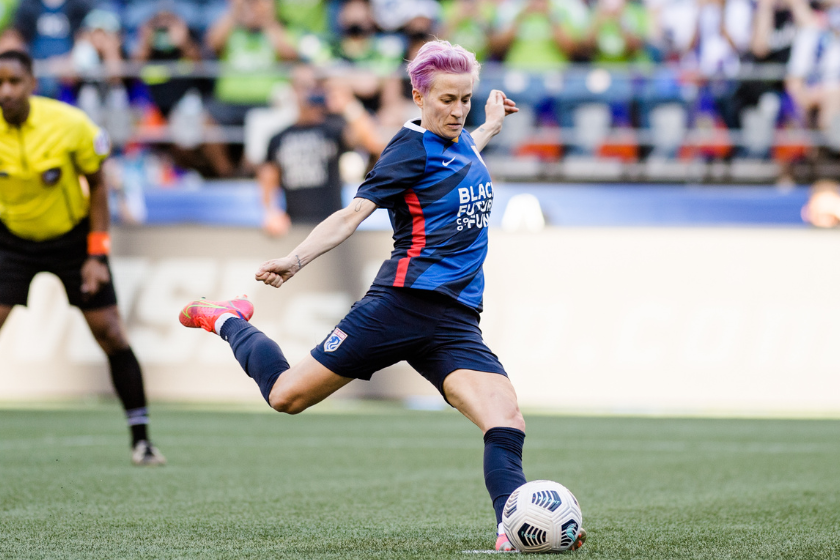 Megan Rapinoe #15 of the OL Reign strikes the ball during a penalty kick during a game between Portland Thorns FC and OL Reign at Lumen Field