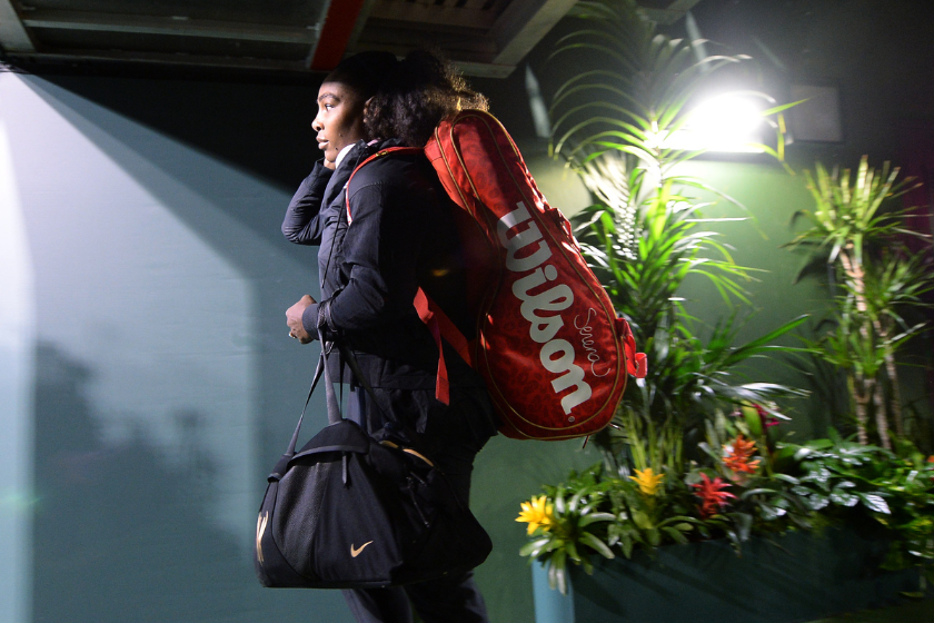 Serena Williams walks out of the tunnel for her first round tennis match against Zarina Diyas