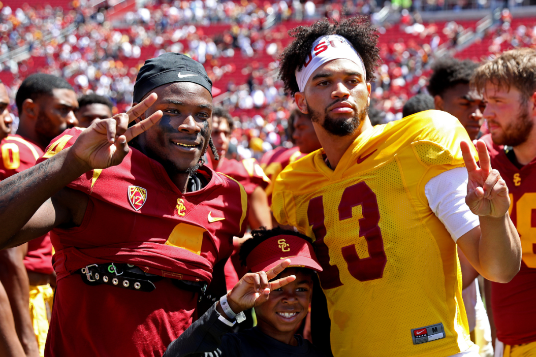 USC wide receiver Mario Williams (4) and USC quarterback Caleb Williams (13) pose for a photograph with a fan at the conclusion of the USC Football Spring Game