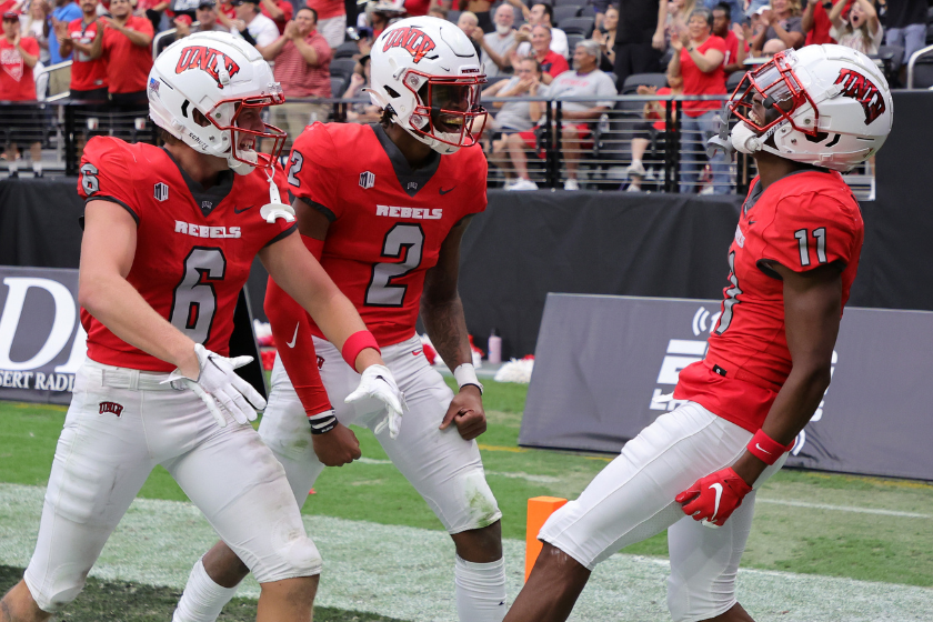 Wide receiver Jeff Weimer #6, quarterback Doug Brumfield #2 and wide receiver Ricky White #11 of the UNLV Rebels celebrate in the end zone after Brumfield hit White for a 72-yard touchdown pass