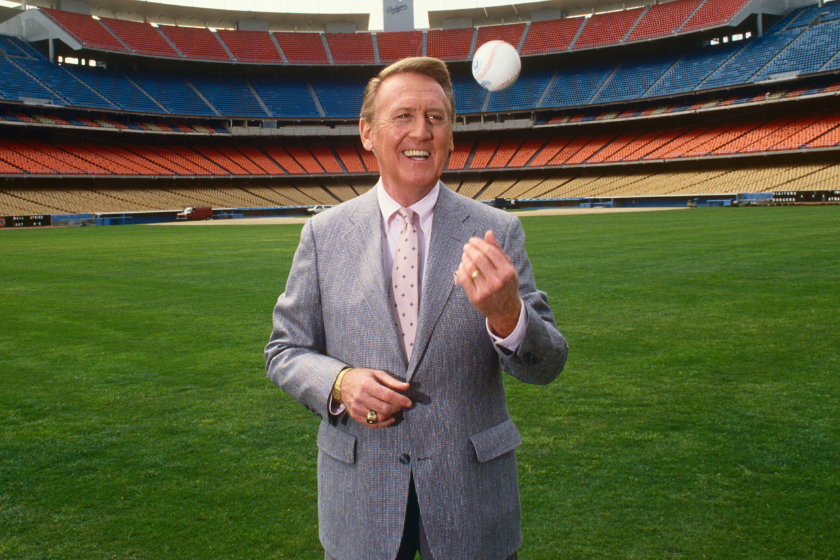 oice of the Los Angeles Dodgers radio broadcasts, Vin Scully, poses in the outfield of Dodger Stadium