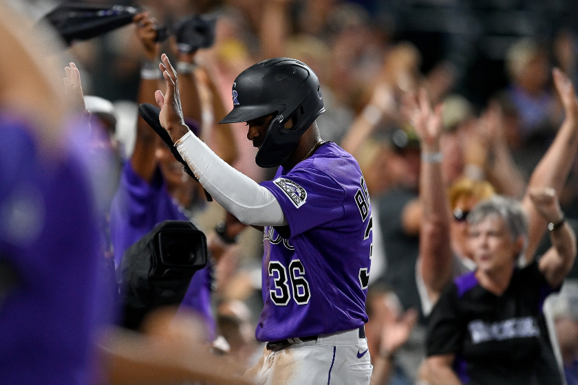 Wynton Bernard #36 of the Colorado Rockies celebrates after scoring a run on a sacrifice fly ball in the seventh inning of a game against the Arizona Diamondbacks at Coors Field
