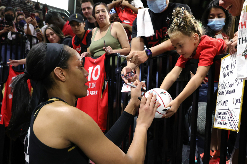 A'ja Wilson #22 of the Las Vegas Aces signs an autograph for Layne Thompson, 5, of South Carolina 
