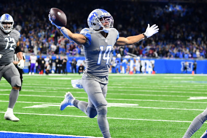 Amon-Ra St. Brown #14 of the Detroit Lions celebrates after catching a touchdown as the time expired to defeat the Minnesota Vikings 29-27