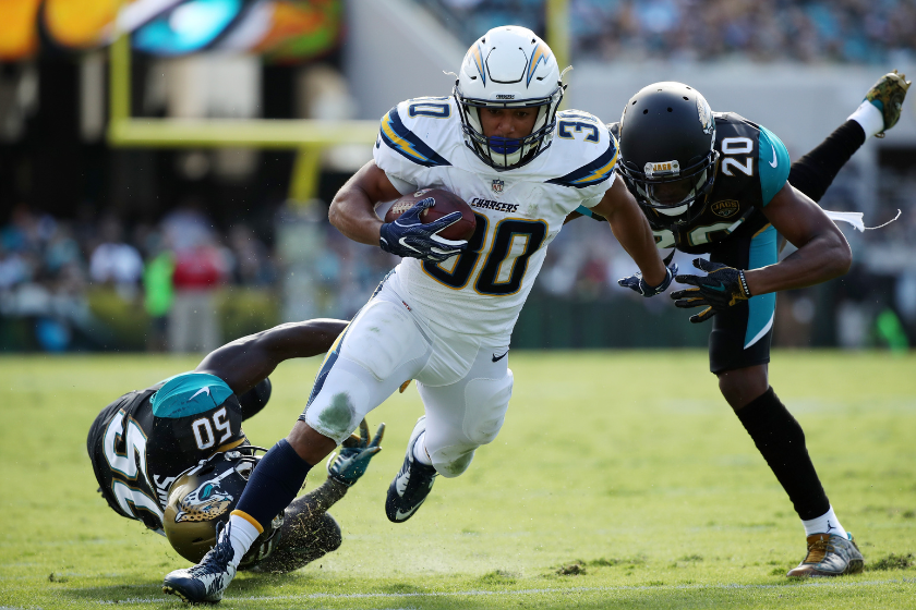 Austin Ekeler #30 of the Los Angeles Chargers beats Telvin Smith #50 and Jalen Ramsey #20 of the Jacksonville Jaguars for a 28-yard touchdown