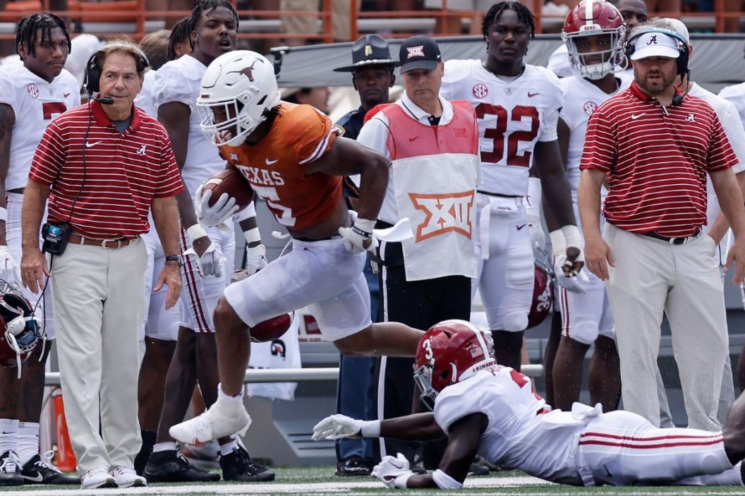 Bijan Robinson #5 of the Texas Longhorns is forced out of bounds by Terrion Arnold #3 of the Alabama Crimson Tide in the third quarter