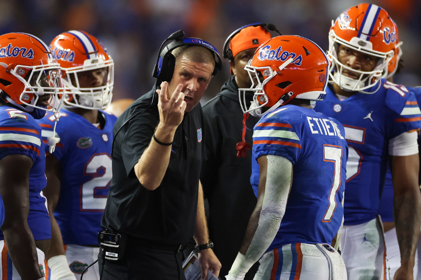 Head coach Billy Napier of the Florida Gators talks with Trevor Etienne #7 during the 4th quarter of a game