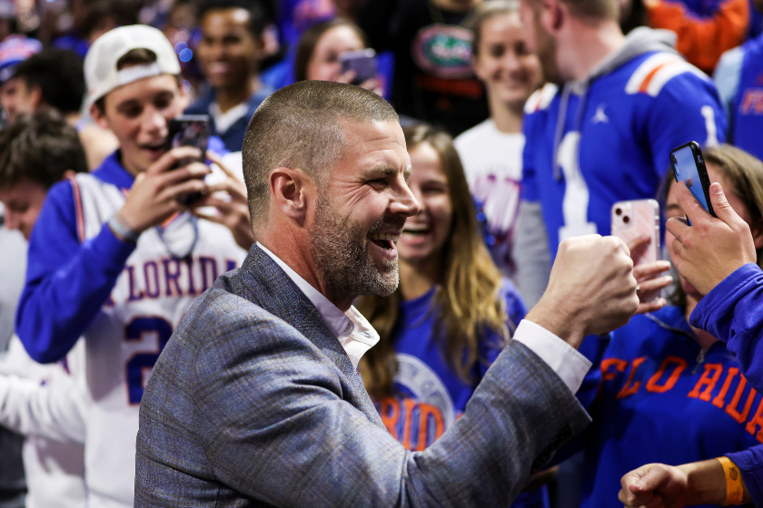 Billy Napier interacts with Florida fans at a basketball game.