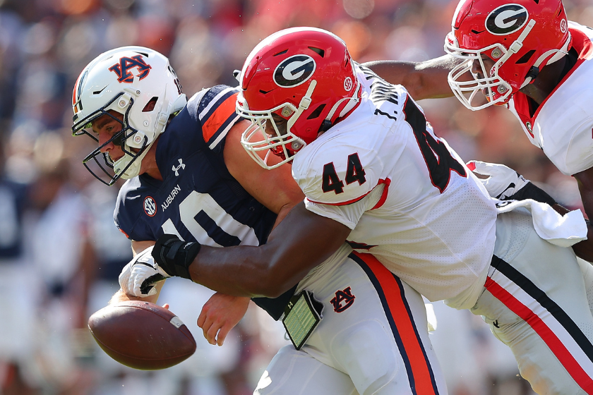  Bo Nix #10 of the Auburn Tigers fumbles the ball as he is tackled by Travon Walker #44 and Adam Anderson #19 of the Georgia Bulldogs
