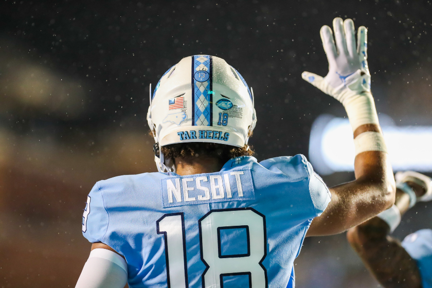 Bryson Nesbit (18) of the North Carolina Tar Heels celebrates in the rain after scoring a touchdown during a football game between the North Carolina Tar Heels and the Florida A&M