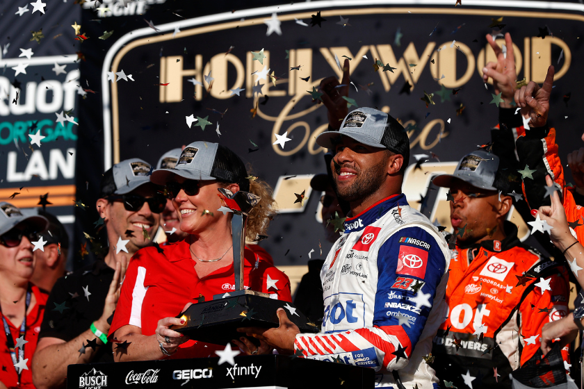 Bubba Wallace receives the Kansas Speedway Casino 400 trophy in victory lane after winning the 2022 Hollywood Casino 400 at Kansas Speedway