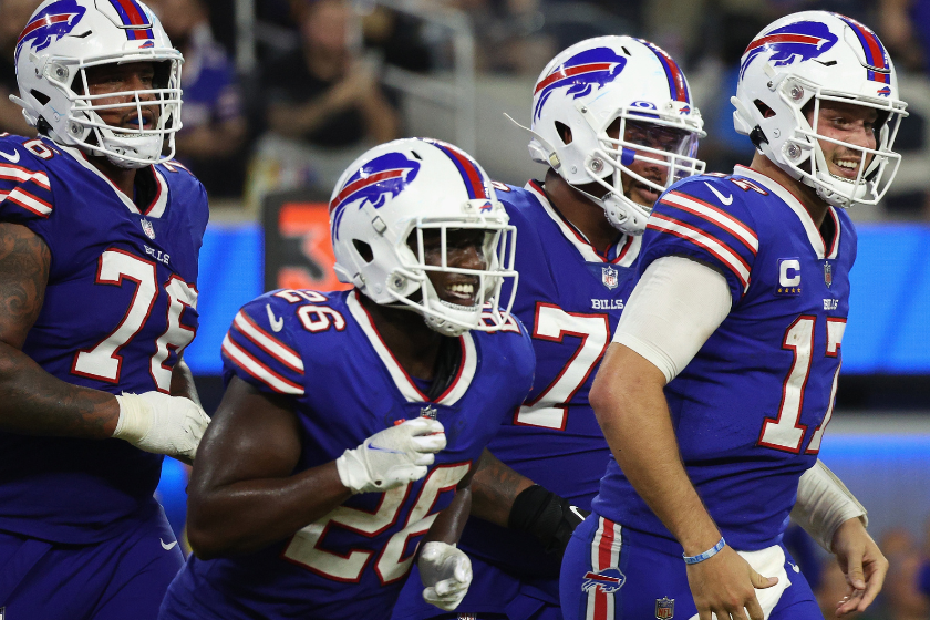 Quarterback Josh Allen #17 of the Buffalo Bills reacts with running back Devin Singletary #26 after Allen scored a four-yard rushing touchdown against the Los Angeles Rams