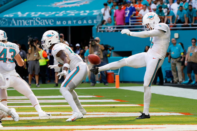 The Butt Punt: Miami Dolphins punter Thomas Morstead (4) punts the ball off the backside of Miami Dolphins wide receiver Trent Sherfield (14) for a safety during the game between the Buffalo Bills and the Miami Dolphins